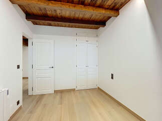 Discover this charming room featuring exposed wooden beams and a rustic wooden ceiling, adding warmth and character.