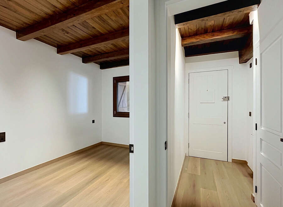 Experience rustic charm and modern comfort in this beautifully renovated space, featuring exposed wooden beams and a warm, inviting atmosphere.