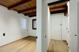 Experience rustic charm and modern comfort in this beautifully renovated space, featuring exposed wooden beams and a warm, inviting atmosphere.