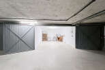 Discover this spacious garage with two large metal doors, offering ample storage and parking.