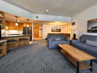 Experience comfortable living in this spacious open-concept condo, featuring a modern kitchen with ample cabinetry and a breakfast bar perfect for casual dining.