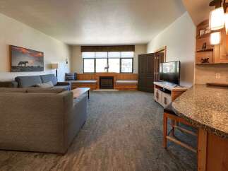 Experience ultimate comfort in this spacious living area, featuring a cozy fireplace and ample seating.