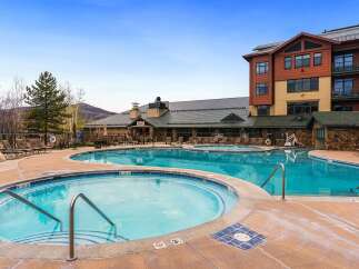 Experience luxury resort living with this stunning property featuring a large, multi-level swimming pool and a relaxing hot tub.