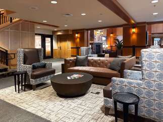 Experience ultimate comfort and style in this inviting lobby featuring plush leather seating and a large, textured coffee table perfect for gathering.