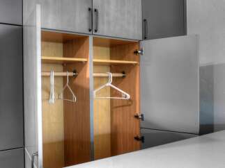 Discover smart storage solutions with this modern closet featuring two open compartments, each equipped with a hanging rod and a shelf.
