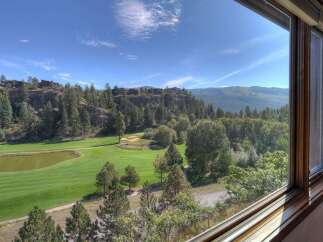 Experience breathtaking panoramic views from this stunning property, overlooking a pristine golf course and lush green fairways.