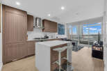 Experience modern living in this stunning condo featuring a sleek kitchen with integrated appliances and a spacious island perfect for entertaining.