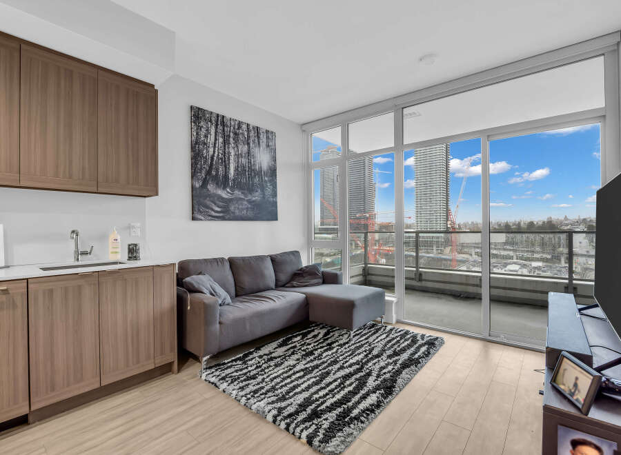 Experience modern urban living in this stylish condo featuring a sleek kitchen with ample cabinet space and a spacious living area.