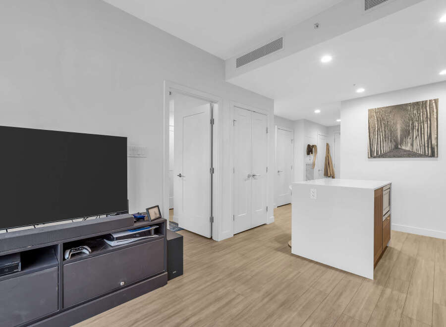 Experience modern living in this bright and airy open-concept space, featuring a sleek kitchen island perfect for entertaining.