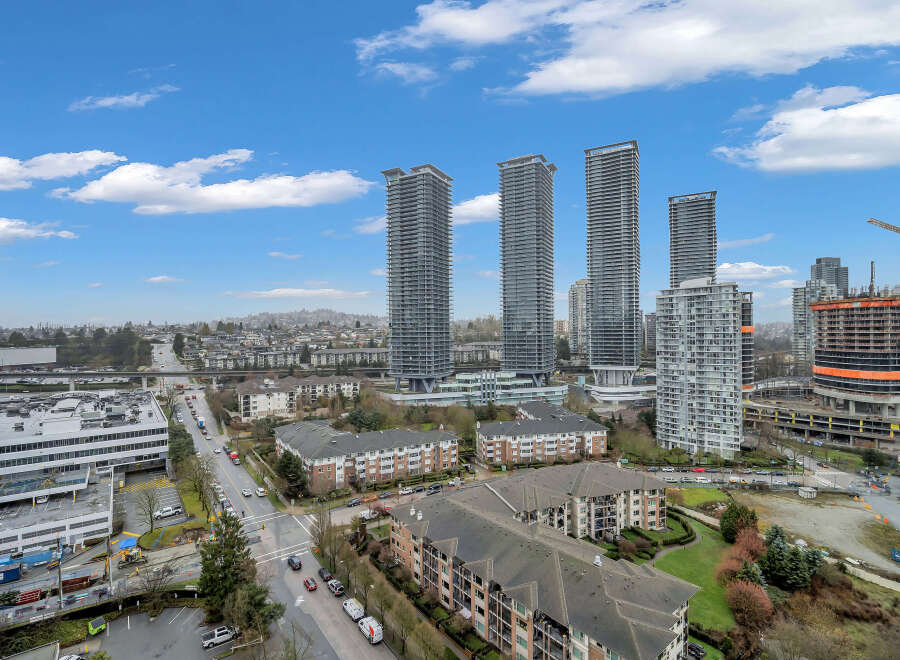Experience modern urban living in this vibrant cityscape featuring sleek high-rise apartments and ongoing construction for future developments.