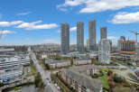Experience modern urban living in this vibrant cityscape featuring sleek high-rise apartments and ongoing construction for future developments.