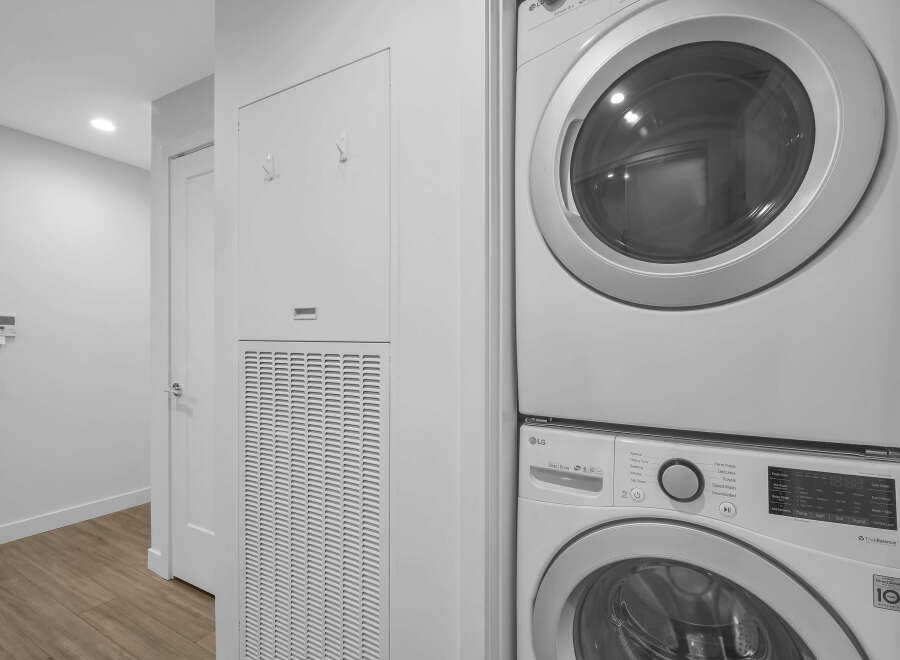 This laundry area features a stacked LG washer and dryer, perfect for maximizing space in your home.