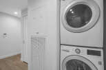 This laundry area features a stacked LG washer and dryer, perfect for maximizing space in your home.