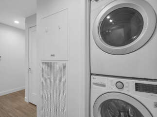 This laundry area features a stacked LG washer and dryer, perfect for maximizing space in your home.