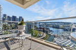 Experience breathtaking waterfront living from this stunning balcony, offering panoramic views of the marina and city skyline.