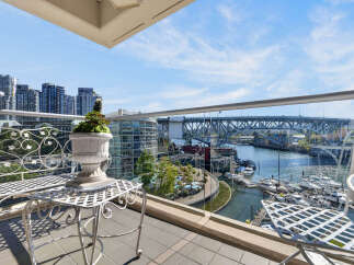 Experience breathtaking waterfront living from this stunning balcony, offering panoramic views of the marina and city skyline.