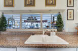 This kitchen features a spacious double basin sink set into a granite countertop, perfect for meal prep and cleanup.