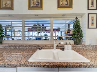 This kitchen features a spacious double basin sink set into a granite countertop, perfect for meal prep and cleanup.