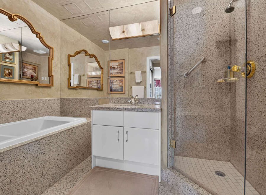 Indulge in luxury with this stunning bathroom featuring a deep soaking tub and a spacious walk-in shower.