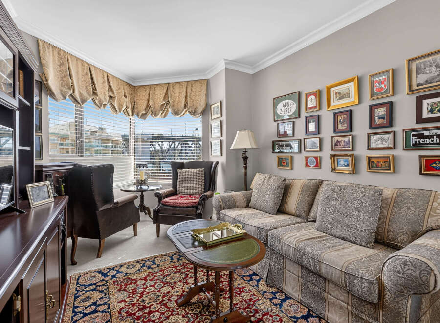 Step into this elegant living room, featuring a plush sofa and armchairs perfect for relaxation.