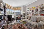 Step into this elegant living room, featuring a plush sofa and armchairs perfect for relaxation.