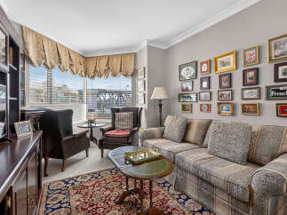 Step into this elegant living room, featuring a plush sofa and armchairs perfect for relaxation.