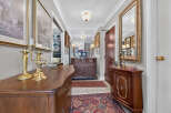 Step into this elegant hallway, featuring a grand antique dresser and a matching side cabinet, perfect for storage and display.