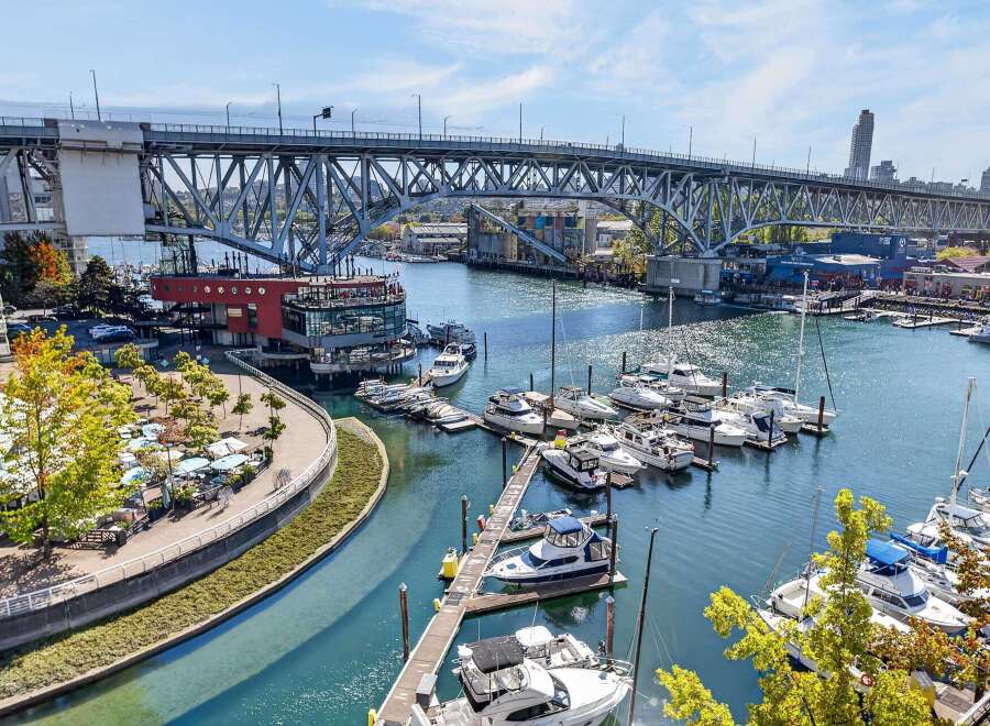 Experience waterfront living at its finest with this stunning property offering panoramic views of the marina and a majestic bridge.