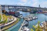 Experience waterfront living at its finest with this stunning property offering panoramic views of the marina and a majestic bridge.