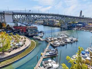 Experience waterfront living at its finest with this stunning property offering panoramic views of the marina and a majestic bridge.