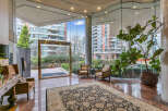 Step into a grand entrance with gleaming marble floors and a large, ornate rug, creating an elegant first impression.