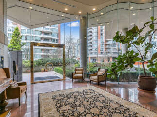 Step into a grand entrance with gleaming marble floors and a large, ornate rug, creating an elegant first impression.