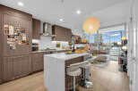 Experience modern urban living in this stunning condo featuring a sleek, contemporary kitchen with ample cabinetry and a spacious island perfect for entertaining.