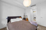 Experience comfort and style in this inviting bedroom, featuring a plush bed adorned with soft linens and decorative pillows.