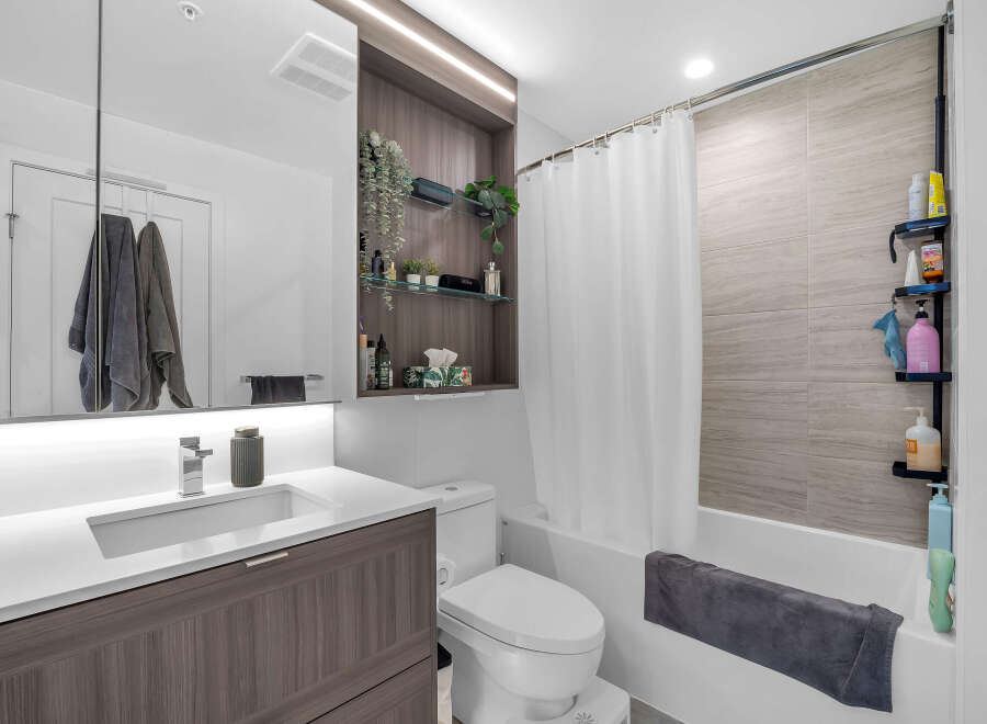Experience modern comfort in this beautifully appointed bathroom, featuring a sleek vanity with ample storage and a stylish chrome faucet.