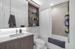 Experience modern comfort in this beautifully appointed bathroom, featuring a sleek vanity with ample storage and a stylish chrome faucet.