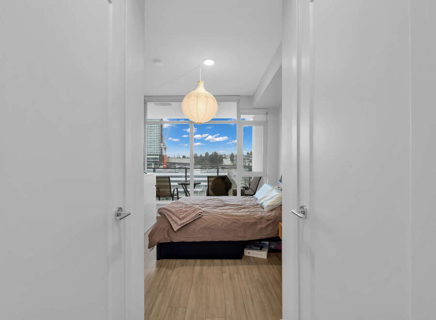 Step into this inviting bedroom featuring a comfortable bed with plush bedding and a stylish accent throw.