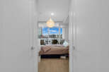 Step into this inviting bedroom featuring a comfortable bed with plush bedding and a stylish accent throw.