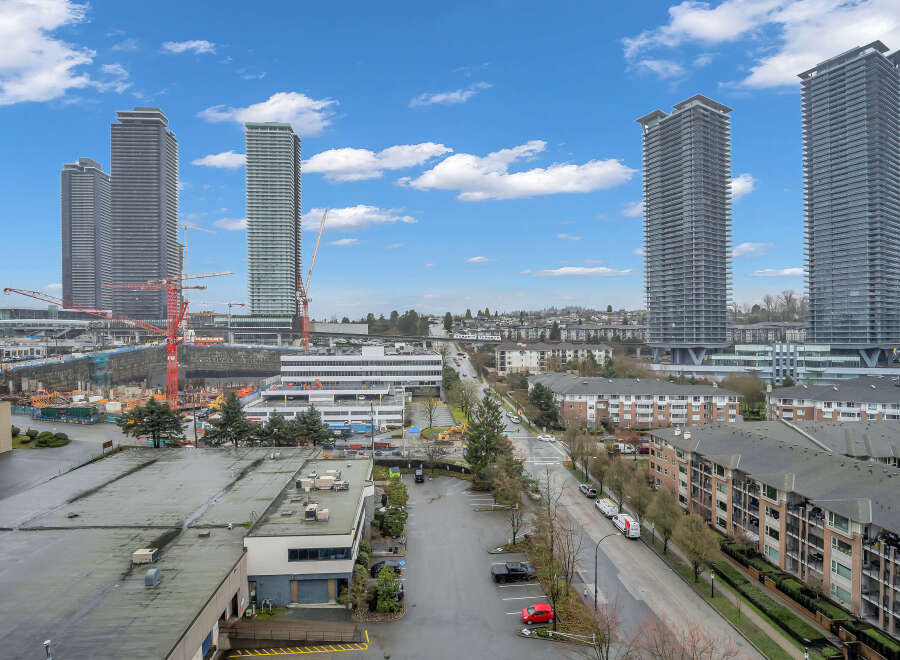 Experience modern urban living in this vibrant cityscape featuring sleek high-rise towers and contemporary apartment buildings.