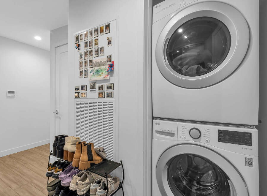 Discover modern convenience with this stacked LG washer and dryer set, perfect for optimizing space in your laundry area.