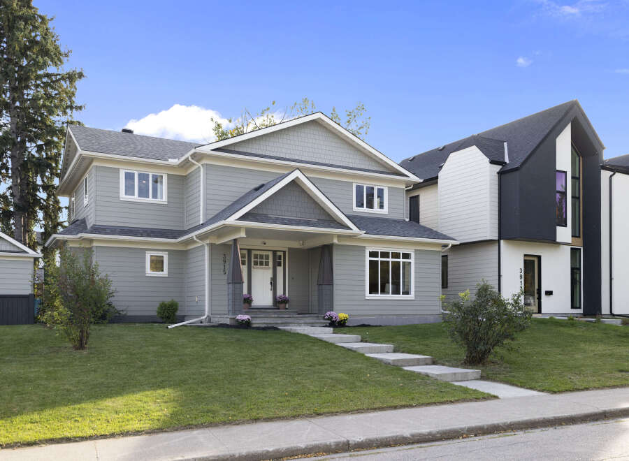 Discover modern living in this stunning new construction home, featuring a sleek grey exterior with contrasting white trim and a prominent gable roofline.