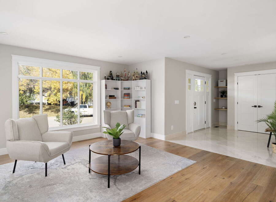 Step into this inviting living room featuring a large window with abundant natural light and scenic views.