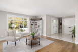 Step into this inviting living room featuring a large window with abundant natural light and scenic views.