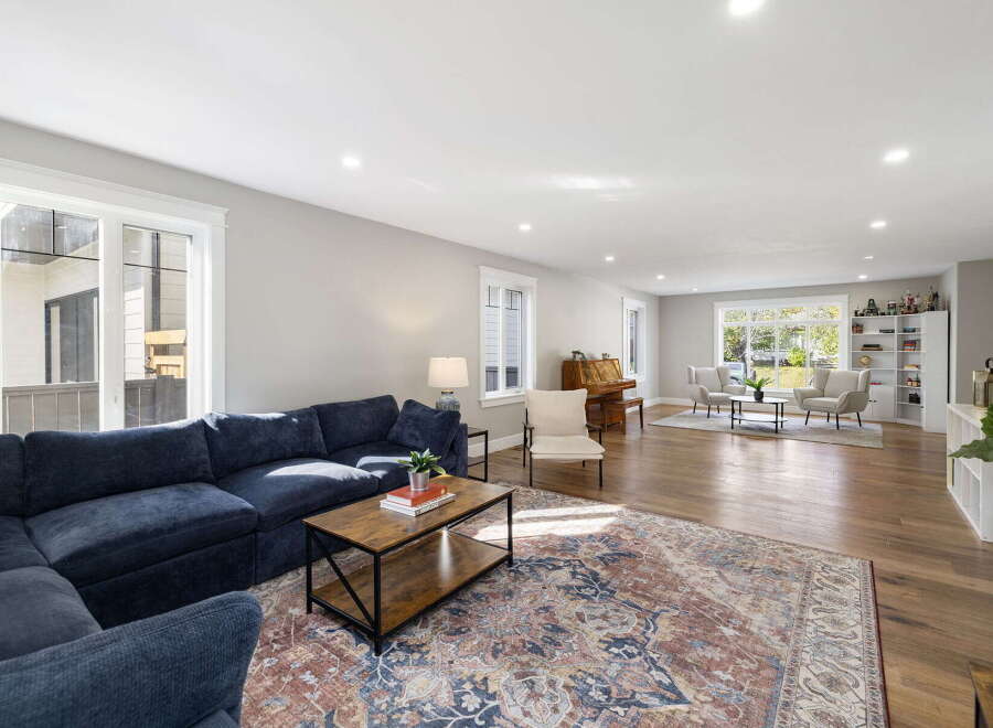 Experience spacious living in this beautifully appointed home, featuring a large sectional sofa perfect for gatherings and a cozy reading nook by the window.