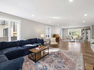 Experience spacious living in this beautifully appointed home, featuring a large sectional sofa perfect for gatherings and a cozy reading nook by the window.