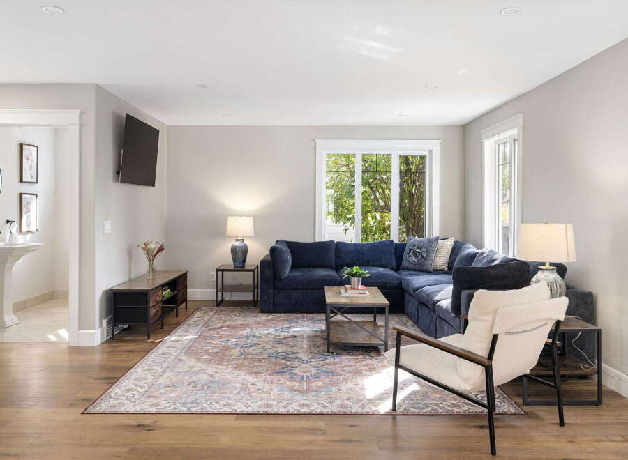 Step into this inviting living room, featuring a plush navy sectional sofa perfect for relaxation and entertaining.