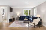 Step into this inviting living room, featuring a plush navy sectional sofa perfect for relaxation and entertaining.