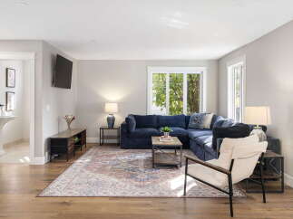 Step into this inviting living room, featuring a plush navy sectional sofa perfect for relaxation and entertaining.