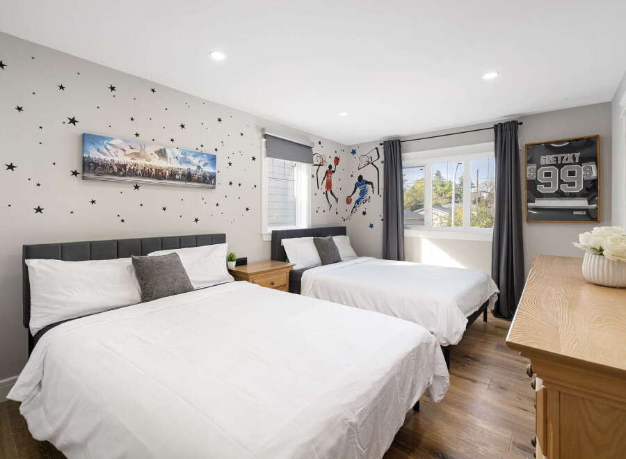 This charming bedroom features two comfortable beds, perfect for families or guests.