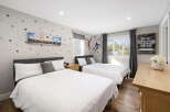This charming bedroom features two comfortable beds, perfect for families or guests.
